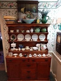 Dontcha just LOVE that 80's floral wallpaper? Umm hmm... Well, older generations just love their nests and sometimes can't see very well, so they keep the wallpaper for decades, until it's cool again. This is not one of those designs that will stand the test of time. Nice vintage cherry hutch, with tons of cups/saucers, Beleek, milk glass - all things you lie awake at night and wonder where you can find more pieces to add to your collection.