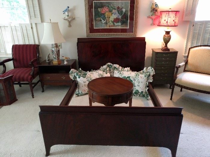 Very nice 1940's mahogany full size bed, with waterfall design and beautifully matched veneers and comes complete with head/foot board and side rails. The round drum table is a one-drawer, by Hekman