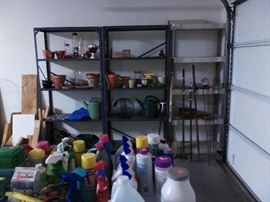 Garage with gardening tools and cleaning supplies.