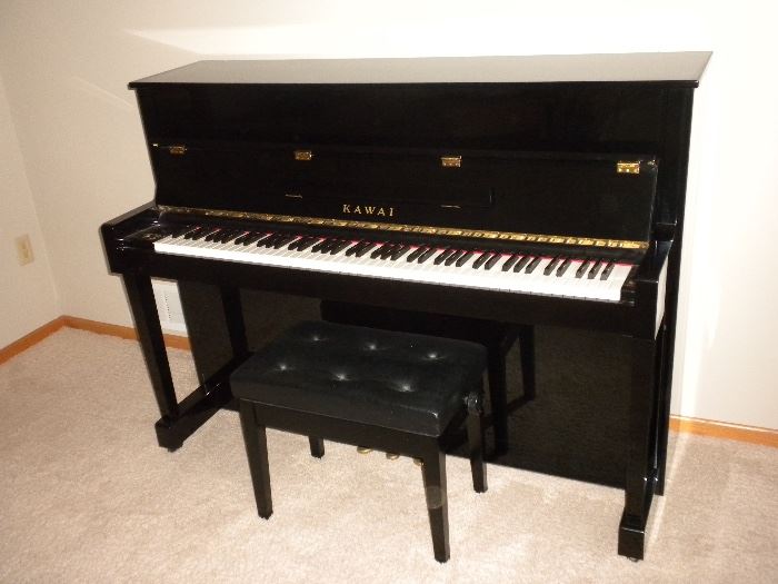 Kawai CX-10 Upright Piano with High-Gloss Black Finish in Pristine Condition: Full 44” Height, Ultra-Responsive, Exclusive ABS Styran Action Parts, Solid Spruce Soundboard, Four Laminated Backposts, Nickel Plated Tuning Pins, Toe-Block Design with Casters for Easy Moving. Tufted Black Stool Included (seat is 22" wide and 14" deep). Seat has Adjustable Height.
