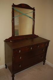 Antique chest of drawers with mirror displayed