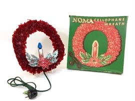 1940s Sparkling Noma Cellophane Wreath

1940s Sparkling Vintage Noma cellophane wreath with Halo candle, measures approx 9 inches with blue lighted electric candle & cardboard poinsettia with original box. Tested and works!
