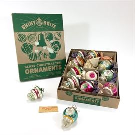 Lot of 12, 1937 box of glass Christmas ornaments. This nice multi-cored set of 12 ornaments are in the original box. Includes hand written note by the owner that purchased them the first year she was married 1937, she writes that these were the only ornaments they could afford. 

Most are a oval to round shape with a pointed bottom. They all have wonderful hand painted details such as stripes, bursts, etc. and have colors of pink (may have been red which is now faded), gold, white, and blue. Ornaments have some aging with some wear and fading to the finish, but are otherwise solid with no cracks or chips and all have the hangers at the top.