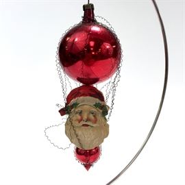 Antique Victorian glass Christmas ornament with a long pike, wire wrapped with some tinsel decoration with scrap Santa face . 5.5 inches tall. Estimated value $210.