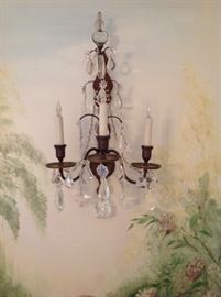 One of a pair of French antique gilt iron and rock crystal sconces