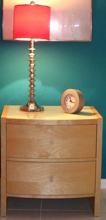 Palliser Furniture Mfg. Canada Mid-Century Style Natural Finish 2-drawer Night Stand with White Glass Top shown with 1 of a pair Chrome Spool Candlestick Lamps and a Silver IKEA Quartz Clock