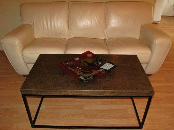 Embossed Brass Top Table on  Black Metal Box Framed Base Made in India (42"W X 24"D X 18"H) shown in front of a Ivory Leather Sofa
