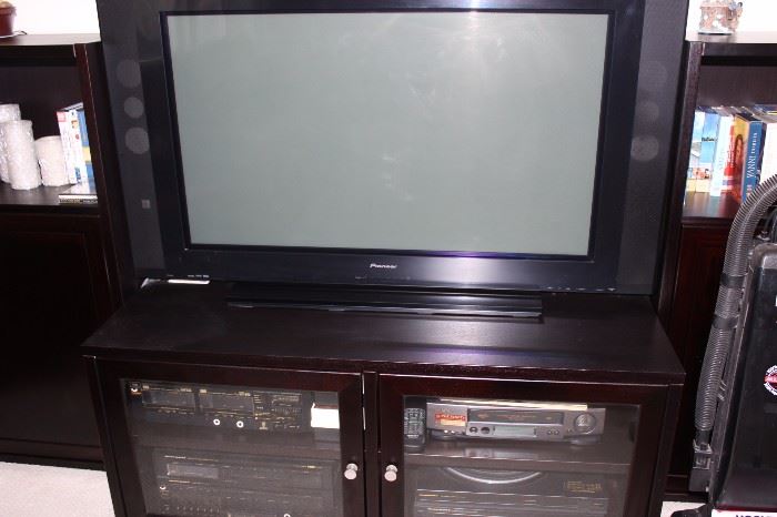 Flat screeen TV, and stand and stereo components, DVD player, VCR and boom box.
