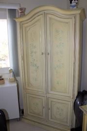Decorative clothing armoire.