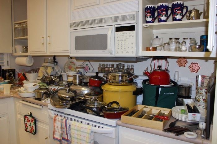 Kitcen filled with everything. Vintage Pyrex, Corning ware. Cookware, flatware, appliances.