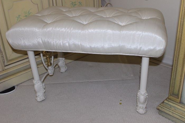 Tufted cushion top bench with iron legs.
