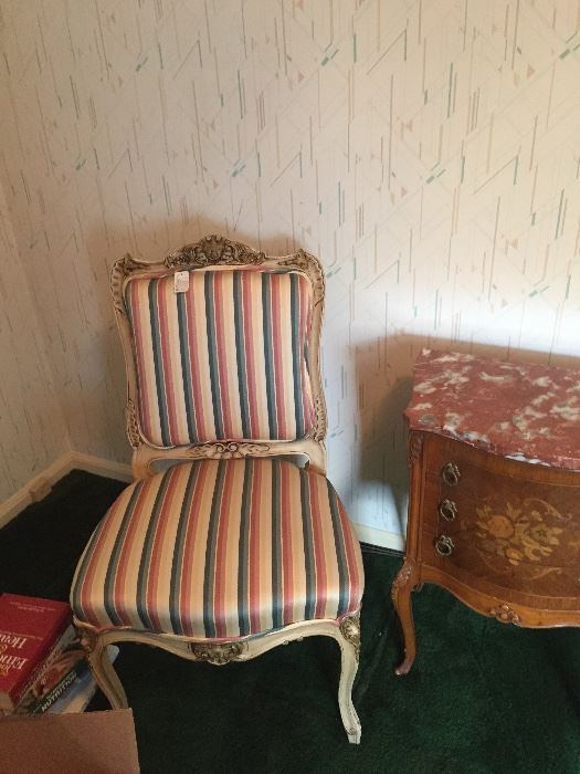 One of a pair of old French side chairs with striped upholstery.