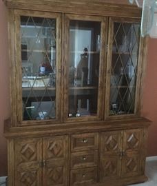 Lit china cabinet 64"w x 18"d x 80"t,  with plenty of storage in the glass case above and the 2 cabinets and 3 drawers below. 