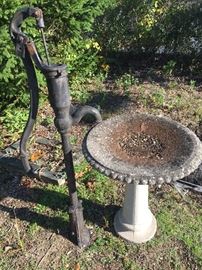 bird bath and antique cast iron water pump