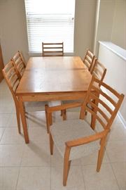 Teak kitchen table and chairs - 53 14" long x 35 1/2" wide x 29" tall . With extension 92 3/4" long. 6 Chairs