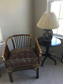 Wicker chair and pillow, cherry table, lamp