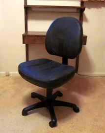 Black vinyl swivel desk chair on wheels, adjustable height and back.