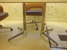 Retro dinette set in great condition. Oval laminate top table with double metal pedestal base, plus 4 padded, vinyl covered, swivel bucket chairs on wheels. Table measures 60" x 41-1/2"