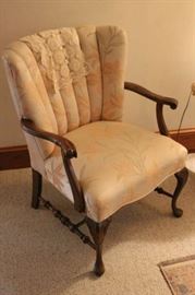 one of two solid nicely upholstered armchairs