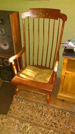 A pair of JBL Stereo Speakers or HiFi speakers. A vintage hardrock maple Rocking Chair. A worn Persian Style Machine made rug. A modern microwave cart on wheels.