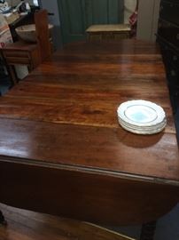 This is view of the walnut spool legged dining table with some of the leaves and this drop leaf table would extend to 10' feet.
