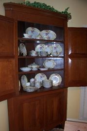 Antique walnut corner cupboard - in pristine condition.  Shown in the cupboard is a beautiful set of antique china - a service for 12