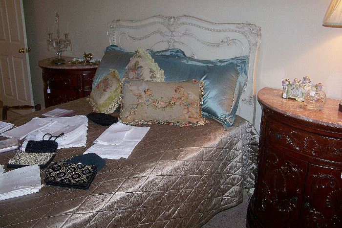 A view of the bed - needlepoint pillows-  pretty linens