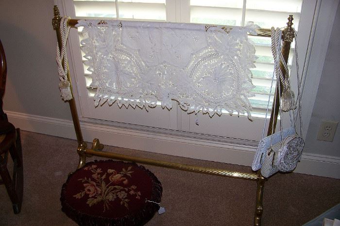 Brass quilt rack with a needlepoint stool