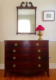 Early 19th C Mahogany Bow Front Chest Of Drawers, Semi-Antique Mirror, Vintage Brass Oil Lamp with Red Shade (Electric, Chimney Intact)
