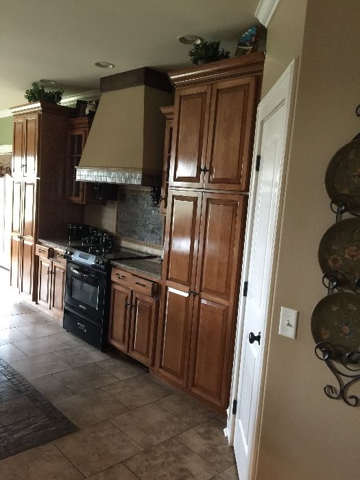 Beautiful custom made kitchen cabinets, build in stove and hood.  All for sale at this home.  