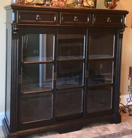 The entryway into this house features this beautiful distressed wall unit.  Glass shelves gives anyone who needs to display items or use as a bookcase. The special feature to this items it has a touch light located into front of the piece. Just tap the button on the entire piece lights up.  Very nice for any room in a home. 