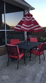 Patio table with umbrella, 4 chairs and 2 matching rocker/swivel chairs and ottomans