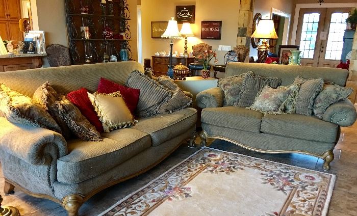 Elegant and charming is this rolled arm footed sofa and matching love seat.