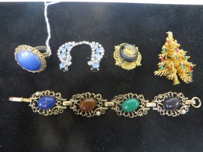 Assortment of costume jewelry including a cobalt and gilt brooch in an antique like gilded frame