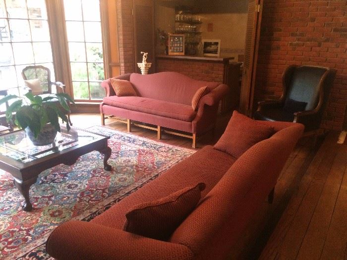 area rugs, sofa , coffee table, leather chairs , bar items