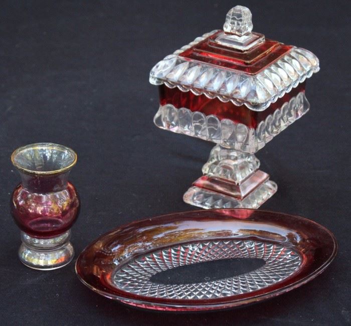 Ruby Glass Trio

Very pretty Ruby Glass. Nice variety. Lidded, footed candy dish is 8"t.

Oval dish is almost 9"l.

Small vase is 4"t. The paint is chipping on the bottom.  