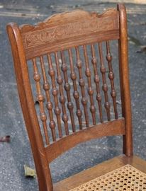 Antique Spindle Chair

Well kept in a non-smoking home. Very good condition.

Measures 37 1/2"T x 16 1/2"W x 15"D

Has a caned seat, undamaged. Made of oak.