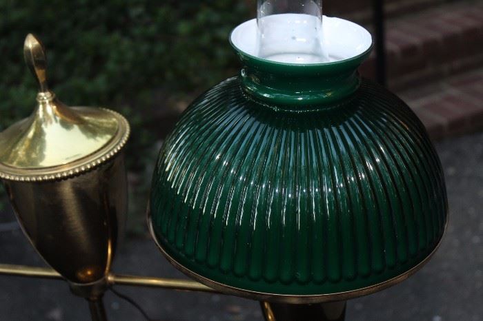 Vintage Student Lamp

Tested and working. Very well kept in a non-smoking home.

Measures 24"T and 27 1/2"W

Gold-colored metal lamp with two lights protruding from either side, decorative finial in center. Round, green glass lampshades on both sides with clear hurricane shade within. 