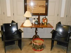 tilt top mahogany table .Italian leather chairs, vintage drum, and Hungarian watercolor