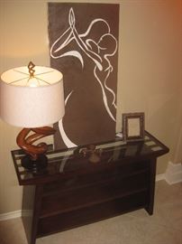 twisted wood lamp, TV console table and canvas of dancing couple