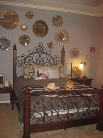 iron and wood bed, decorative mirrors, decorative pillows