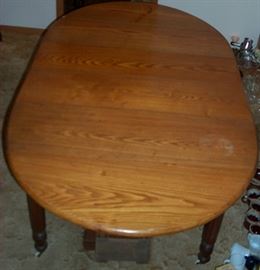Dining room table w/ 2 leaves (76 in. long by 44 in. W) and 3 extra leaves below