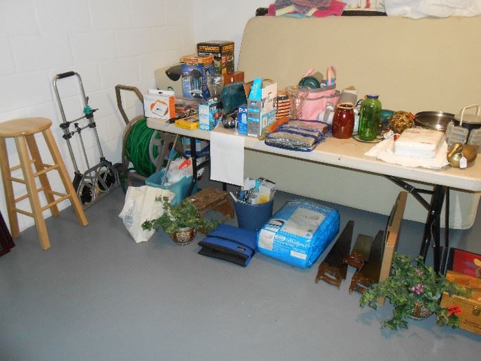 $5.00 each item area.  Stool, hose and reel, hand truck, saws, coolers, Hull pottery, new diapers, pans, brass duck, wood clothes pins, bucket of bulbs, spin mop, bug zappers and accessories, more. 