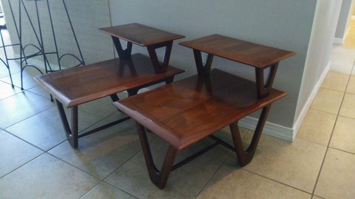 Two mid-century modern two-tier walnut side tables with hairpin leg configuration.