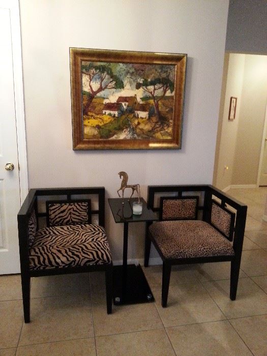 Two Asian inspired corner chairs with animal print.