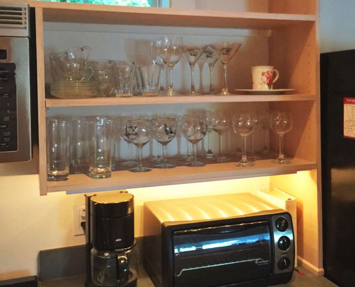 Tumblers, coffee cups, and wine glasses -- and some of the many kitchen items. 