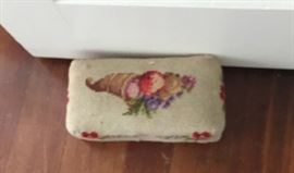 Needlepoint-covered brick doorstop