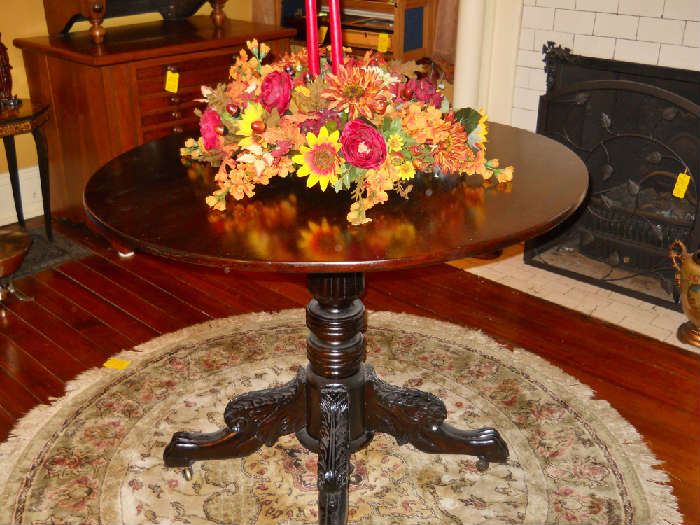 tilt top table with heavily carved legs
