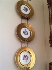Handpainted porcelain plates with heavily encrusted gold trip.  Each with a different scene - 8 plates