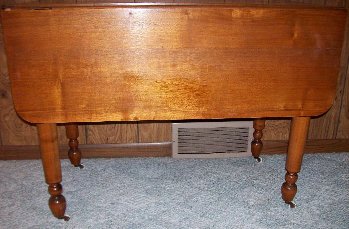         Antique drop leaf table with turned legs & casters